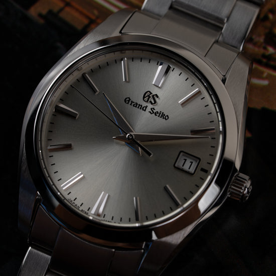 Grand Seiko Heritage Collection SBGX263 - sfeerbeeld onder een hoek met zilveren wijzerplaat tegen decoratieve achtergrond