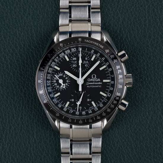 Omega Speedmaster Day-Date 3520.50 - volledig horloge recht van boven met zwarte wijzerplaat en dag-datumaanduiding