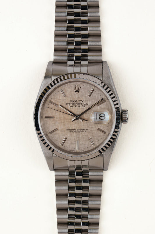 Rolex Datejust 16234 - vooraanzicht van de zilveren wijzerplaat, geribbelde witgouden bezel en armband